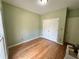 Small bedroom featuring hardwood floors, a single window, and a closet at 235 Pirkle Ct, Cumming, GA 30040