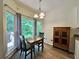 Quaint dining area features large windows showcasing a green backyard view at 235 Pirkle Ct, Cumming, GA 30040