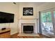 A detailed view of the fireplace with a marble hearth, decorative screen, and mantel at 235 Pirkle Ct, Cumming, GA 30040