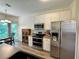 Charming kitchen with stainless steel appliances and an adjacent dining area at 235 Pirkle Ct, Cumming, GA 30040