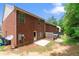 Brick townhouse features a fenced backyard with a small patio, providing a private outdoor space for relaxation and enjoyment at 2714 Haynescrest Dr, Grayson, GA 30017