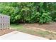 Lush backyard features mature trees, natural landscaping, and a cozy patio, ideal for outdoor relaxation and entertaining at 2714 Haynescrest Dr, Grayson, GA 30017