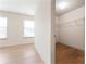 Bedroom with a walk-in closet, wood-look floors, and two windows at 2714 Haynescrest Dr, Grayson, GA 30017