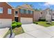 View of a traditional brick townhome featuring a two-car garage and a neatly landscaped front yard at 2714 Haynescrest Dr, Grayson, GA 30017