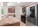 Bright kitchen with stainless steel appliances, stone countertops, and light wood floors at 2714 Haynescrest Dr, Grayson, GA 30017