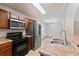 A kitchen featuring stainless steel appliances, double sink, and stone countertops at 2714 Haynescrest Dr, Grayson, GA 30017