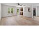 Spacious living room with wood flooring, large windows, and a view of the adjacent kitchen at 2714 Haynescrest Dr, Grayson, GA 30017