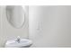 Stylish powder room with a modern vanity and a round mirror at 2714 Haynescrest Dr, Grayson, GA 30017