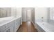 Modern bathroom features grey cabinets, double vanity, soaking tub and glass shower at 2975 Jefferson St, Austell, GA 30106