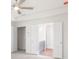 Bright bedroom features light, neutral carpet, ceiling fan and view to a bathroom at 2975 Jefferson St, Austell, GA 30106