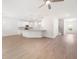 Open-concept living room featuring wood-look floors, kitchen, and staircase at 2975 Jefferson St, Austell, GA 30106