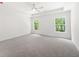 Spacious main bedroom featuring neutral carpet, tray ceiling, and natural light at 2975 Jefferson St, Austell, GA 30106