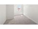 Spacious walk-in closet features neutral carpet, white walls and a window at 2975 Jefferson St, Austell, GA 30106