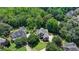 A captivating aerial shot showcases a stately home nestled amongst mature trees at 6010 Somerset Ct, Suwanee, GA 30024