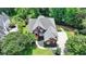 Stunning aerial view of a traditional brick home with lush landscaping and a large driveway at 6010 Somerset Ct, Suwanee, GA 30024