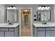 Dual sink bathroom vanity with framed mirrors and modern lighting fixtures at 6010 Somerset Ct, Suwanee, GA 30024