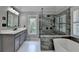 Beautiful bathroom featuring a soaking tub and marble walk-in shower with glass surround at 6010 Somerset Ct, Suwanee, GA 30024