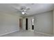 Bedroom showcasing neutral walls, carpet, ceiling fan, and bathroom access at 6010 Somerset Ct, Suwanee, GA 30024