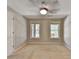 Neutral bedroom with carpet and two windows providing natural light at 6010 Somerset Ct, Suwanee, GA 30024