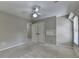Bedroom with carpet flooring, ceiling fan, and access to closet at 6010 Somerset Ct, Suwanee, GA 30024