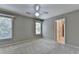 Bedroom with two windows, a ceiling fan, carpet, and ensuite access at 6010 Somerset Ct, Suwanee, GA 30024