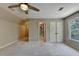 Spacious bedroom featuring large windows and plush carpet at 6010 Somerset Ct, Suwanee, GA 30024