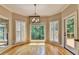 Breakfast nook with bay windows, shutter blinds and view to the lush greenery outdoors at 6010 Somerset Ct, Suwanee, GA 30024