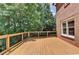 A beautiful wooden deck, surrounded by trees, offering an outdoor living space at 6010 Somerset Ct, Suwanee, GA 30024