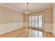 Dining room featuring hardwood floors, wainscoting and hanging chandelier at 6010 Somerset Ct, Suwanee, GA 30024