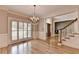 Dining room featuring beautiful chandelier, hardwood floors, and wainscoting at 6010 Somerset Ct, Suwanee, GA 30024