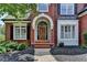 Elegant brick home entrance with arched doorway and decorative front door at 6010 Somerset Ct, Suwanee, GA 30024
