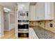 Kitchen features stainless appliances, custom cabinets, granite countertops and built in microwave and oven at 6010 Somerset Ct, Suwanee, GA 30024