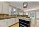 Open concept kitchen with island, granite counters and view to the sunny breakfast nook at 6010 Somerset Ct, Suwanee, GA 30024