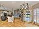 Large open concept kitchen with stainless appliances, granite countertops and hardwood floors at 6010 Somerset Ct, Suwanee, GA 30024
