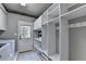 Functional laundry area with shelving, hanging racks, and a utility sink for added convenience at 6010 Somerset Ct, Suwanee, GA 30024