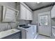 Well-equipped laundry room with modern washer and dryer, sink, and ample storage space at 6010 Somerset Ct, Suwanee, GA 30024