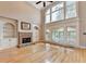 Spacious living room with hardwood floors, stone fireplace, and large windows at 6010 Somerset Ct, Suwanee, GA 30024