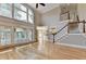 Open living space with beautiful hardwood floors, fireplace, and staircase at 6010 Somerset Ct, Suwanee, GA 30024