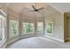 Bright and spacious main bedroom with multiple windows, plush carpeting, and a ceiling fan at 6010 Somerset Ct, Suwanee, GA 30024