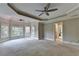 Large main bedroom offers a cozy carpeted space, ceiling fans, and ample natural light from several windows at 6010 Somerset Ct, Suwanee, GA 30024