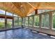 Sunroom with wood ceiling, stone floor, multiple windows and access to the exterior at 6010 Somerset Ct, Suwanee, GA 30024
