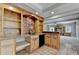 Finished basement wet bar featuring built-in cabinets, copper backsplash and granite countertops at 6010 Somerset Ct, Suwanee, GA 30024
