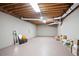 Unfinished basement featuring exposed wood ceiling and painted concrete flooring at 12160 Oak Hollow Way, Alpharetta, GA 30005