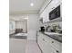 The basement kitchenette features a microwave and counterspace overlooking a living space at 12160 Oak Hollow Way, Alpharetta, GA 30005