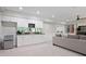 The basement offers a kitchen counter with bar seating, a refrigerator and a large living space at 12160 Oak Hollow Way, Alpharetta, GA 30005