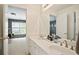 This bathroom features a double sink vanity and access to other rooms via doorways and mirror reflections at 12160 Oak Hollow Way, Alpharetta, GA 30005