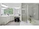 This bathroom features a walk-in shower, a soaking tub, and a makeup vanity in a bright, naturally lit space at 12160 Oak Hollow Way, Alpharetta, GA 30005