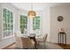 Bright breakfast nook with large windows and modern chandelier lighting at 12160 Oak Hollow Way, Alpharetta, GA 30005