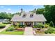Beautiful community clubhouse with manicured landscaping and colorful flower beds at 12160 Oak Hollow Way, Alpharetta, GA 30005