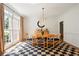 Light filled dining room with hardwood floors, chandelier, and large window at 12160 Oak Hollow Way, Alpharetta, GA 30005